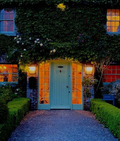 Hotel entrance with green archway over country house door