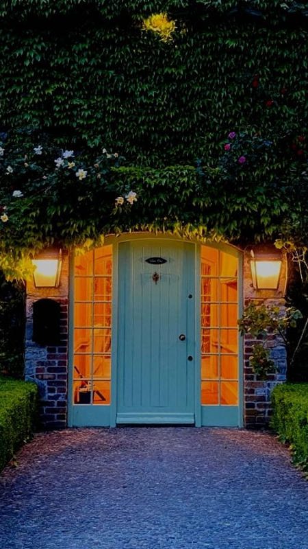 Hotel entrance with green archway over country house door