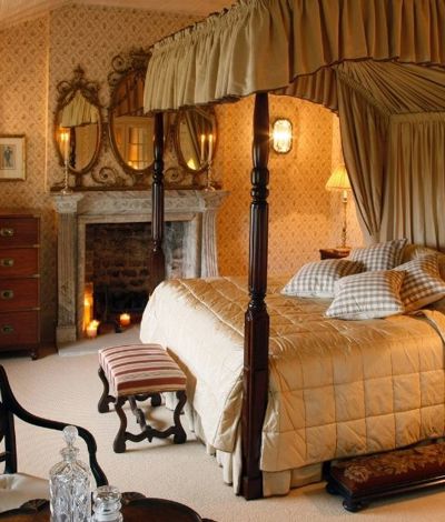 Vintage hotel room with wooden 4 post bed and quilted bed cover