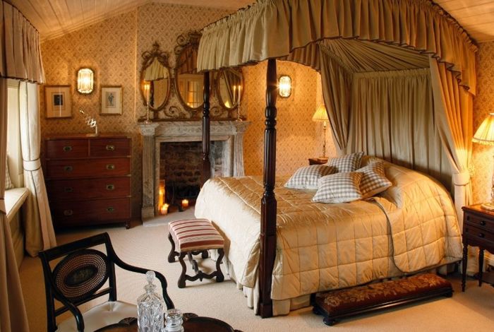 Vintage hotel room with wooden 4 post bed and quilted bed cover