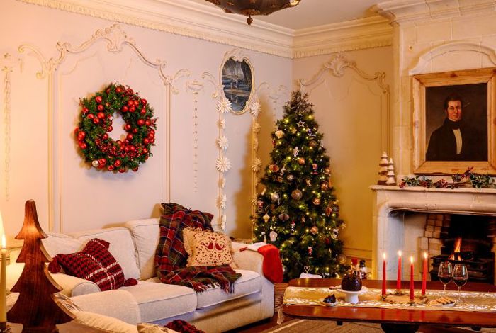 Luxury irish cottage sitting room with open fireplace and christmas decorations
