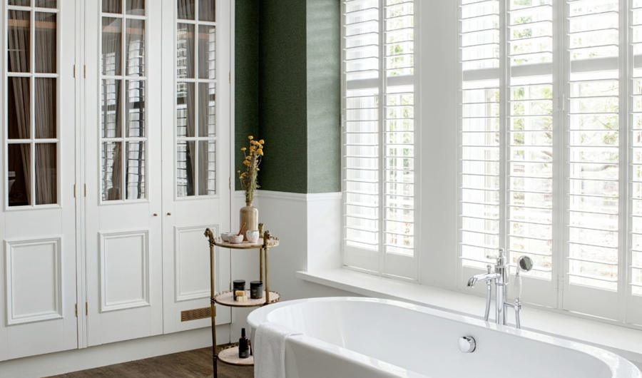 Irish cottage hotel bathroom with wood floors and white bathtub