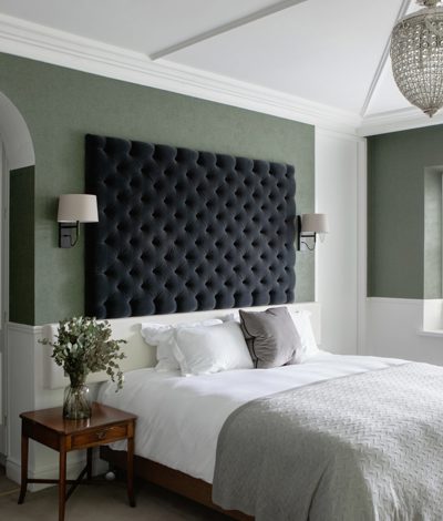 Modern cosy hotel suite with quilted blankets and white linen