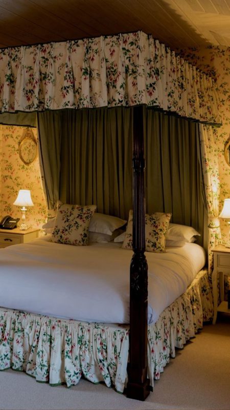 Floral four post bed suite in hotel room