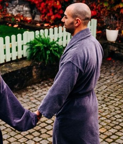 Couple enjoy spa treatment with dressing gowns at hotel