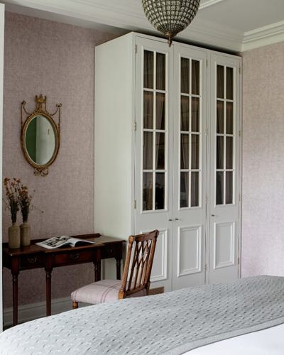 Elegant hotel suite with desk and wooden chair