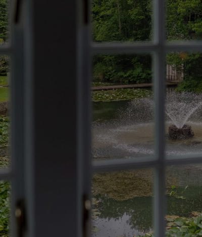 Looking at country house garden through hotel room window