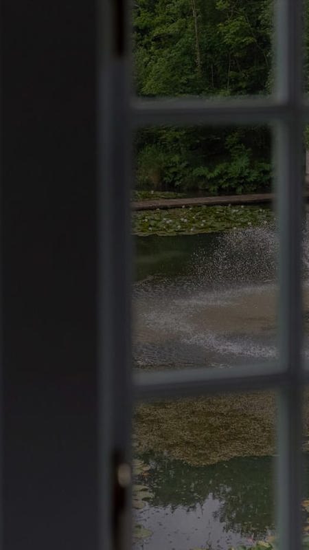 Looking at country house garden through hotel room window