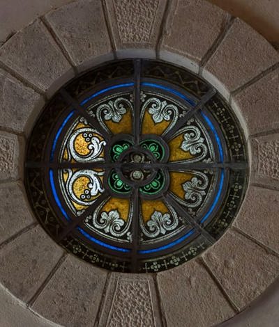 Stain glass windows in sandstone wall at irish country house