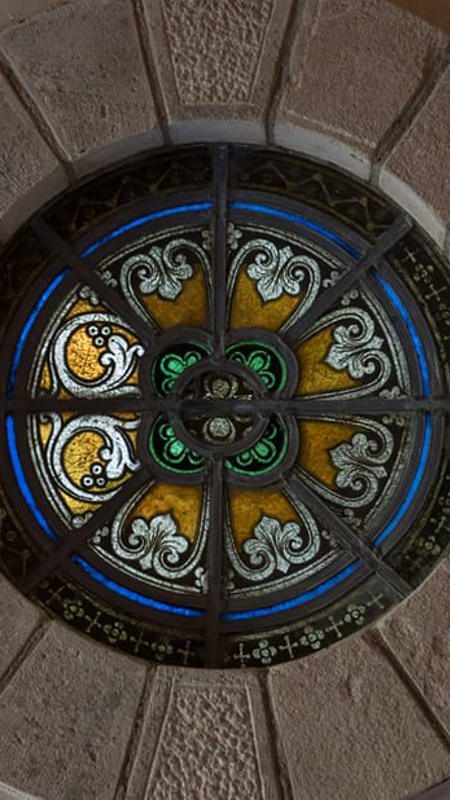 Stain glass windows in sandstone wall at irish country house