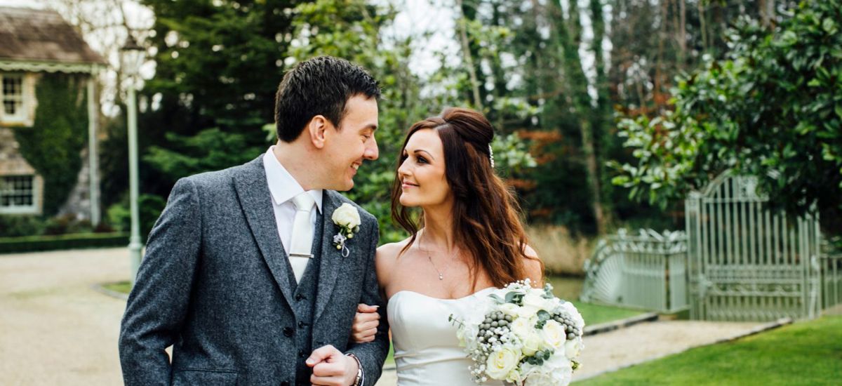Groom smiles at bride at country estate wedding in ireland