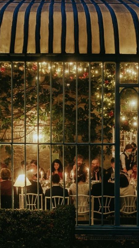 Wedding dinner with candles inside atrium at luxury country estate in ireland