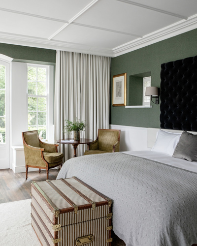 4 star hotel suite with white linen and white carpet