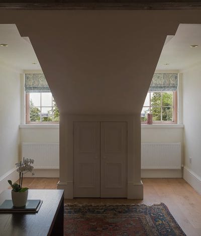 Hote suite with 2 vaulted windoes with garden views
