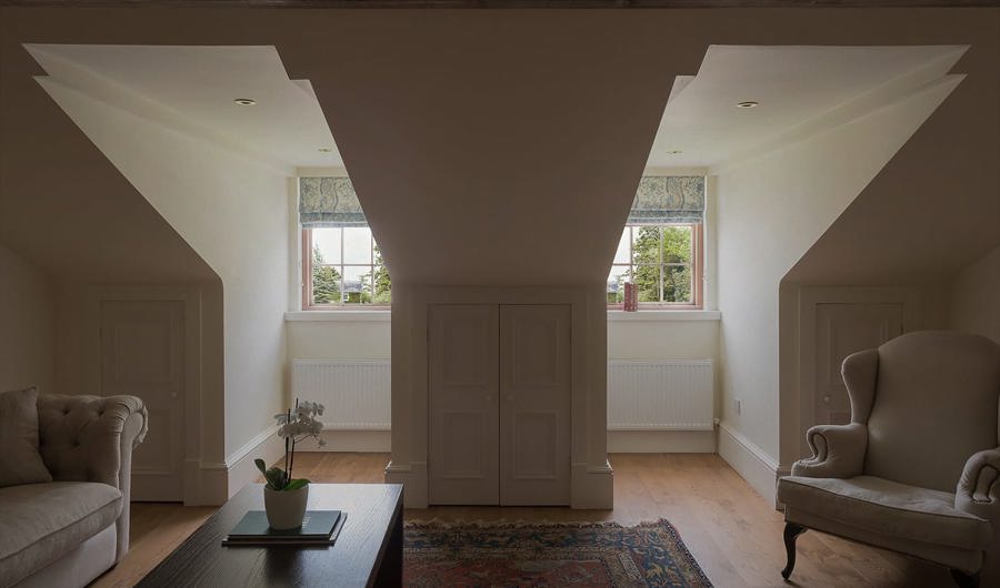 Hote suite with 2 vaulted windoes with garden views