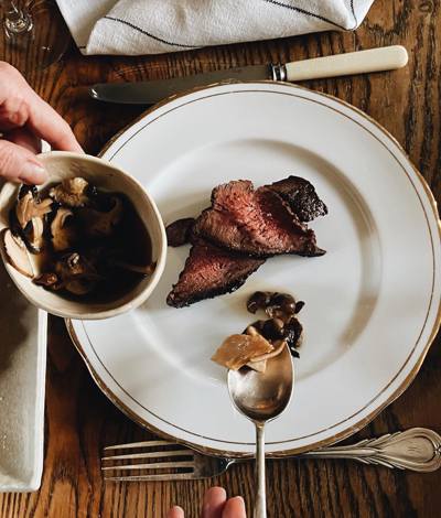 Slices of tender beef with wild mushroom sauce