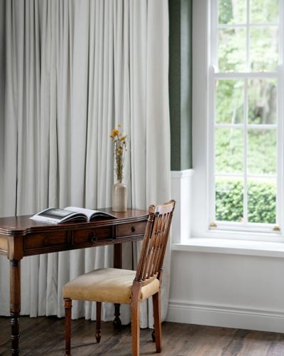 Close u pview of hotel room with wooden desk and chair