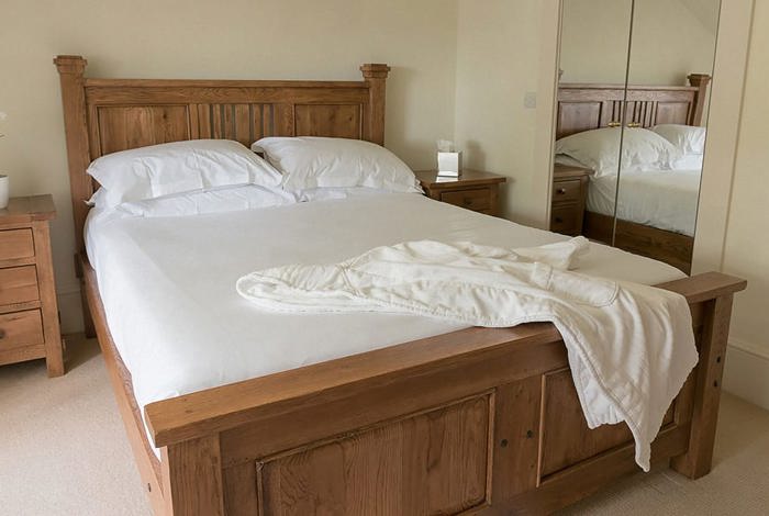 Modern simple hotel room with soft carpet and wooden bed