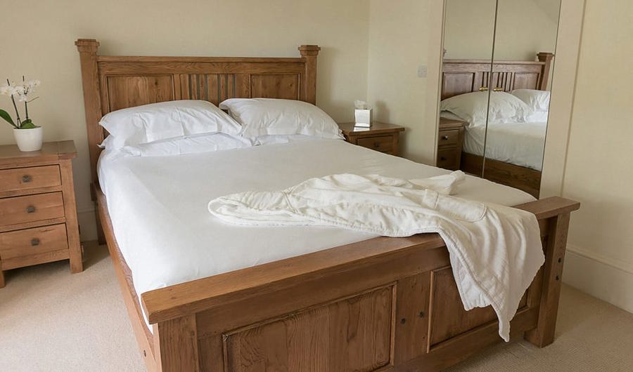 Modern simple hotel room with soft carpet and wooden bed