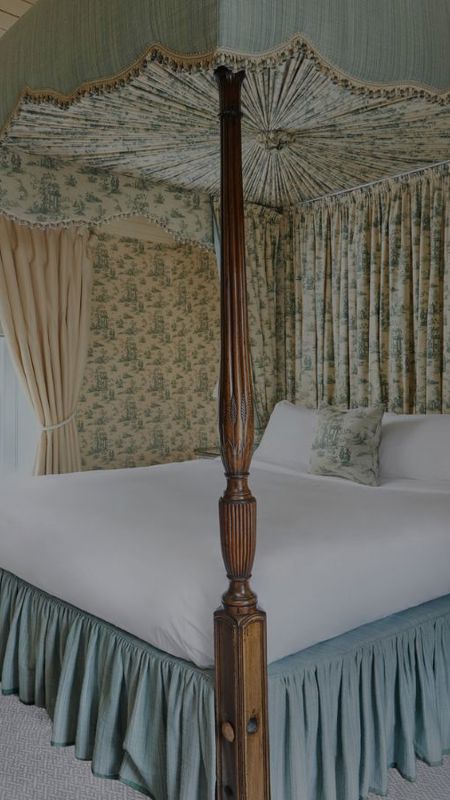 Comfortable 4 post bed with white linen at 4 star hotel