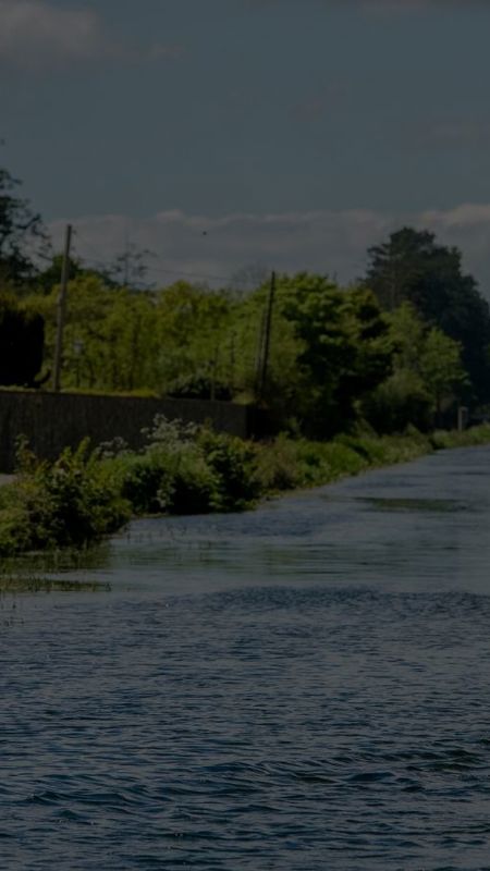 Man paddles kayak in canal near cliff at lyons