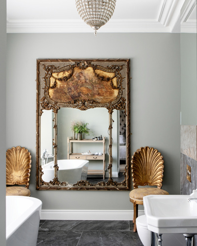 Elegant bathroom with gold fittings and white bath