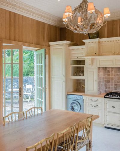 Wood pannelled kitchen with traditional wood fired oven
