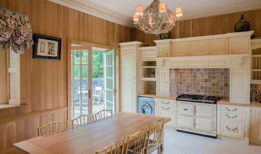 Wood pannelled kitchen with traditional wood fired oven