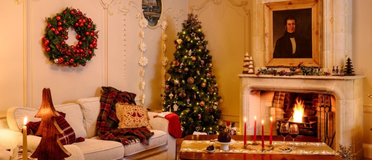 A cosy lounge in a cottage at Cliff at Lyons, dressed with a Christmas tree, cosy couch, and period-styled decor, located in Celbridge, Co. Kildare, just 30 minutes from Dublin