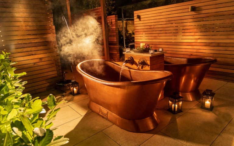 An image of the outdoor copper baths at The Well in the Garden, a tranquil spa in Kildare.